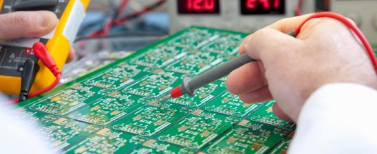 Technician testing a printed circuit board