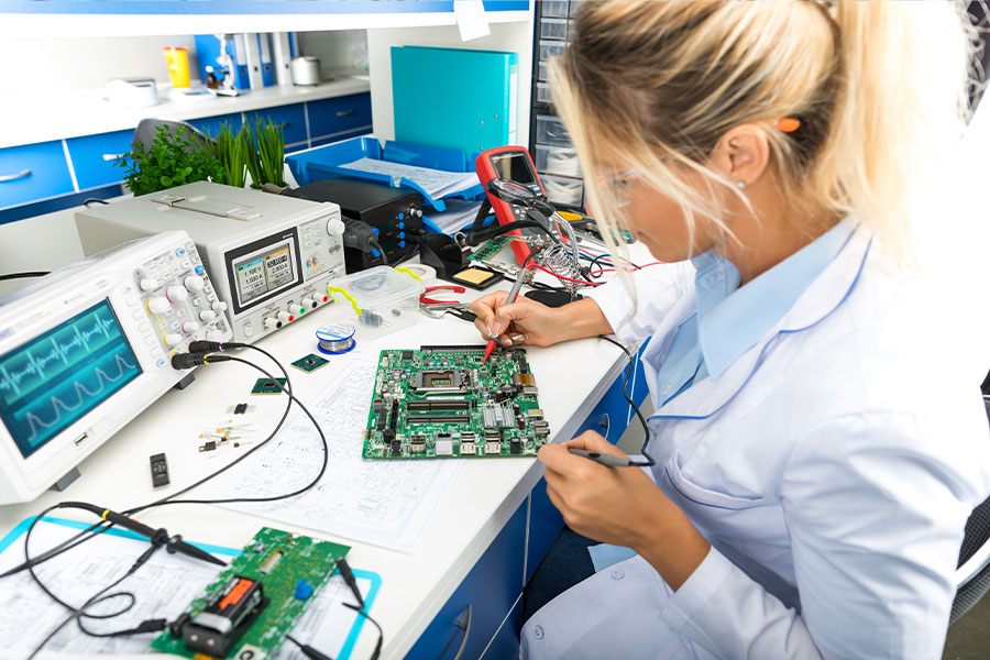 Technician testing a circuit board at a workbench
